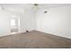 Spacious bedroom with carpet, vaulted ceilings, ceiling fan, and an adjacent bathroom at 4521 Crimson Leaf Dr, Las Vegas, NV 89130