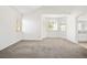 Bedroom featuring carpet, multiple windows for natural light, and an ensuite bathroom at 4521 Crimson Leaf Dr, Las Vegas, NV 89130