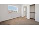 Bright bedroom with carpet, a window overlooking the neighborhood, and an adjacent closet and bathroom at 4521 Crimson Leaf Dr, Las Vegas, NV 89130