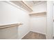 Open walk-in closet featuring carpet, wooden hanging bars, and shelves for storage at 4521 Crimson Leaf Dr, Las Vegas, NV 89130