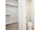 Open closet with carpeted floor, shelving, and a view into an attached bathroom with toilet at 4521 Crimson Leaf Dr, Las Vegas, NV 89130