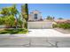 Well-manicured home with lush green lawn and a two-car garage at 4521 Crimson Leaf Dr, Las Vegas, NV 89130