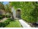 Inviting front yard with lush greenery, flowers, and a well-manicured lawn leading to the entrance at 4521 Crimson Leaf Dr, Las Vegas, NV 89130