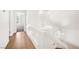 Well-lit hallway with hardwood floors and white walls, offering a clean and modern aesthetic at 4521 Crimson Leaf Dr, Las Vegas, NV 89130