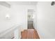 Upstairs hallway with wood flooring leading to a bright bedroom at 4521 Crimson Leaf Dr, Las Vegas, NV 89130