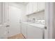 Laundry room with washer, dryer, and overhead cabinets for storage at 4521 Crimson Leaf Dr, Las Vegas, NV 89130
