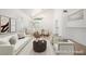 Open-concept living and dining area with neutral tones, stylish furniture and bright windows at 4521 Crimson Leaf Dr, Las Vegas, NV 89130