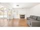 Cozy living room with hardwood floors, a fireplace, and sliding glass doors at 4521 Crimson Leaf Dr, Las Vegas, NV 89130