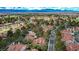 Expansive aerial view showcasing the community's lush landscaping, mature trees and red tile roofs at 5112 Onion Creek Ln, Las Vegas, NV 89113