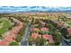 Wide aerial view of a community with lush greenery, a golf course, and scenic views of mountains in the distance at 5112 Onion Creek Ln, Las Vegas, NV 89113