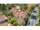 A beautiful home showcases a red tile roof, with mature trees and a swimming pool in a well-kept neighborhood at 5112 Onion Creek Ln, Las Vegas, NV 89113