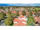 A picturesque aerial view of a desert community featuring well-maintained homes surrounding a beautiful body of water at 5112 Onion Creek Ln, Las Vegas, NV 89113