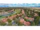 A sprawling community with manicured lawns, lush trees, and a tranquil lake and golf course at 5112 Onion Creek Ln, Las Vegas, NV 89113