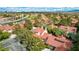 A picturesque aerial view of a desert community featuring well-maintained homes bordering on a lush green golf course at 5112 Onion Creek Ln, Las Vegas, NV 89113