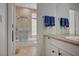 Neutral-toned bathroom features shower-tub combo with blue accent towels and granite vanity countertop at 5112 Onion Creek Ln, Las Vegas, NV 89113