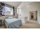 Loft style bedroom featuring high ceilings, a large window and access to an adjoining bathroom at 5112 Onion Creek Ln, Las Vegas, NV 89113