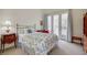 Bright bedroom with outdoor access through glass doors, connecting to a private balcony at 5112 Onion Creek Ln, Las Vegas, NV 89113