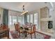 Formal dining room features a dining set for eight, with views to the outdoors and a fireplace at 5112 Onion Creek Ln, Las Vegas, NV 89113