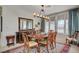 Traditional dining room with large window, beautiful rug, and dining set for eight people at 5112 Onion Creek Ln, Las Vegas, NV 89113