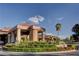 An impressive entrance with a covered drop-off area, manicured landscaping, and a sculpture adds a touch of elegance at 5112 Onion Creek Ln, Las Vegas, NV 89113