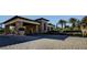 Impressive stone entrance with lush landscaping, showcasing the property's curb appeal and welcoming atmosphere at 5112 Onion Creek Ln, Las Vegas, NV 89113