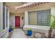 Inviting front entrance with colorful potted plants and a decorative glass block window feature at 5112 Onion Creek Ln, Las Vegas, NV 89113