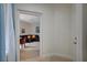 Welcoming hallway leading to a living room area featuring a leather sofa set and bay windows at 5112 Onion Creek Ln, Las Vegas, NV 89113