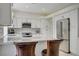 Open kitchen with island seating, stainless steel appliances, and bright, neutral design at 5112 Onion Creek Ln, Las Vegas, NV 89113