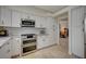Close up of kitchen with stainless steel double oven, granite counters, and white cabinets at 5112 Onion Creek Ln, Las Vegas, NV 89113