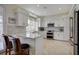 Modern kitchen features white cabinetry, stainless steel appliances, and granite countertops at 5112 Onion Creek Ln, Las Vegas, NV 89113