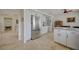 Open concept kitchen with stainless steel refrigerator and abundant cabinet space at 5112 Onion Creek Ln, Las Vegas, NV 89113