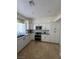 Well-lit kitchen with stainless steel appliances, granite counters and white cabinets at 5112 Onion Creek Ln, Las Vegas, NV 89113