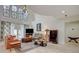 Comfortable living room with stone fireplace, large windows, and neutral color palette at 5112 Onion Creek Ln, Las Vegas, NV 89113