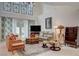 Well-lit living room featuring comfortable seating, a TV, and direct access to the outdoor pool at 5112 Onion Creek Ln, Las Vegas, NV 89113