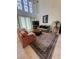 Bright living room boasting large windows and comfortable seating arrangements at 5112 Onion Creek Ln, Las Vegas, NV 89113