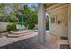 A covered patio area with steps leading to outdoor seating and the pool offers a tranquil retreat at 5112 Onion Creek Ln, Las Vegas, NV 89113