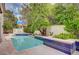 Inviting backyard swimming pool surrounded by lush greenery and a landscaped patio area at 5112 Onion Creek Ln, Las Vegas, NV 89113