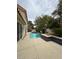 Tranquil backyard pool with tile accents, bordered by lush greenery and a well-maintained patio at 5112 Onion Creek Ln, Las Vegas, NV 89113
