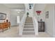Inviting foyer with a staircase, enhanced by neutral tones and tasteful decorative accents throughout at 5112 Onion Creek Ln, Las Vegas, NV 89113