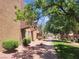 An exterior view of an apartment building with mature trees, green grass, and manicured shrubbery at 5188 River Glen Dr # 453, Las Vegas, NV 89103