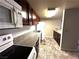 Kitchen view showcasing wooden cabinetry, granite countertops, and standard white appliances at 5188 River Glen Dr # 453, Las Vegas, NV 89103