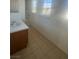 Well-lit bathroom featuring a single sink vanity, tile flooring, and large window at 523 Cabis Bay St, Las Vegas, NV 89178