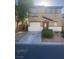 Two story home showcasing a two car garage, landscaped yard, and a charming entryway at 523 Cabis Bay St, Las Vegas, NV 89178