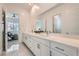 Bright bathroom featuring a dual sink vanity, modern fixtures, and large mirror, leading into an airy bedroom at 5321 Brayden Ct, Las Vegas, NV 89131