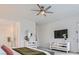 Bright bedroom featuring contemporary furnishings, including mirrored dressers and a mounted TV at 5321 Brayden Ct, Las Vegas, NV 89131