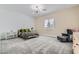 Spacious bedroom with plush carpet, decorative light fixture, and cozy sitting area at 5321 Brayden Ct, Las Vegas, NV 89131