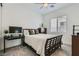 Cozy bedroom with a wooden bed frame, a work desk, and neutral color scheme at 5321 Brayden Ct, Las Vegas, NV 89131