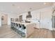 Bright kitchen features stainless steel appliances, a large waterfall island with seating, and custom cabinetry at 5321 Brayden Ct, Las Vegas, NV 89131