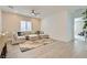 Bright living room with a neutral sectional sofa, accent rug, and modern ceiling fan at 5321 Brayden Ct, Las Vegas, NV 89131