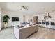 Bright living room features sleek furnishings, a ceiling fan, and is open to the kitchen with stone countertops at 5321 Brayden Ct, Las Vegas, NV 89131